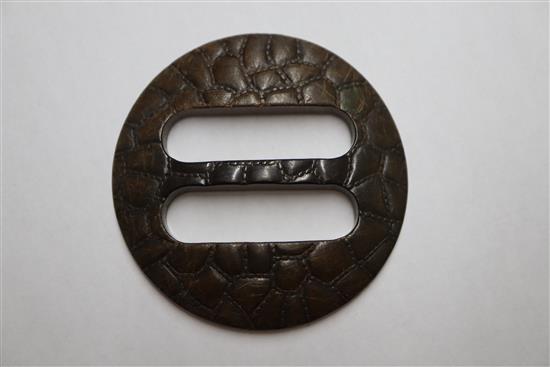 A bakelite buckle and a Scandinavian libation cup.